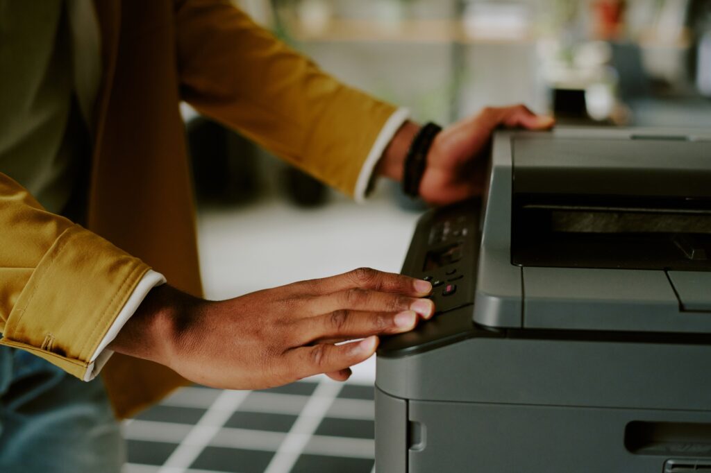 Unrecognizable Man Using Printer